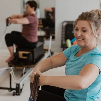 Clients working through a Reformer and Tower session at Momentum Pilates